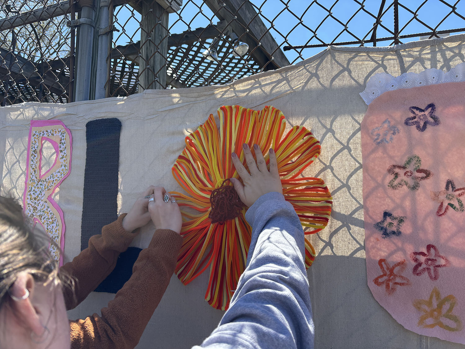 Students from the Craftivism attaching a flower to the project.