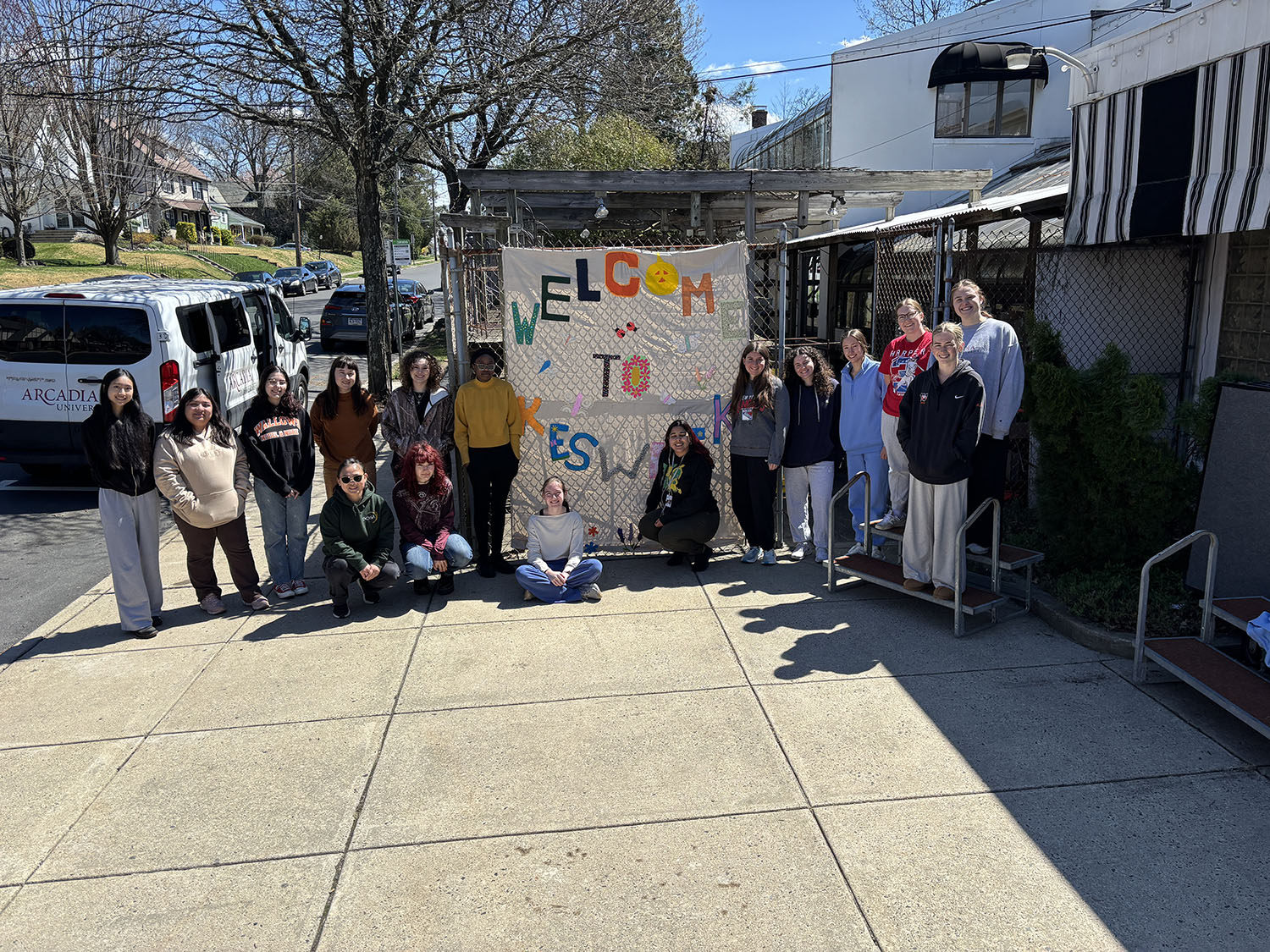 Students from the Craftivism class standing in front of the smaller project.