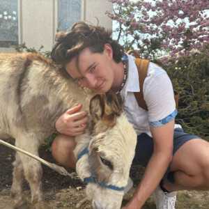 Murphy Hastings hugging a mini horse.