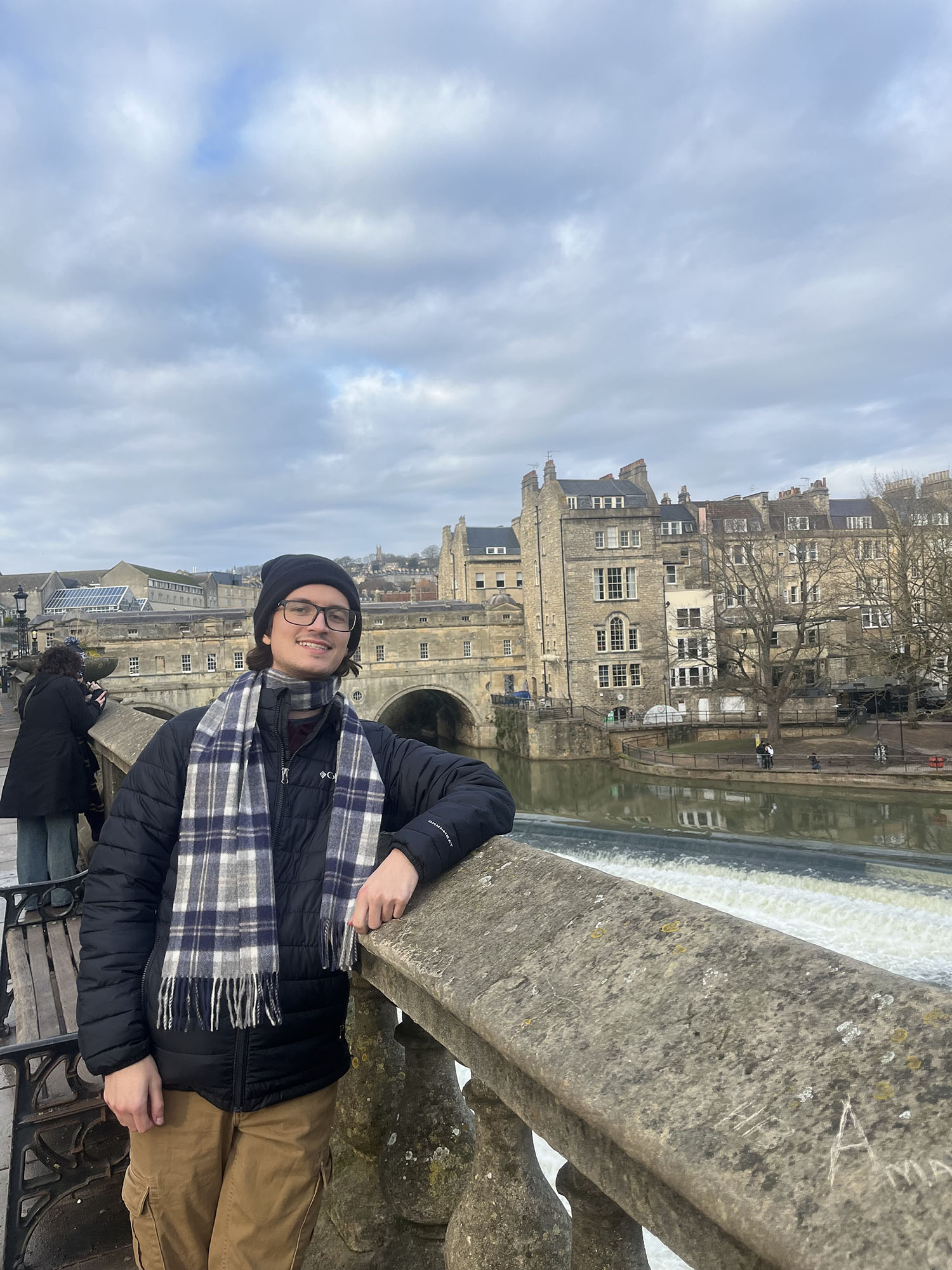Patrick Hood ’26 on a bridge with a castle in the background.