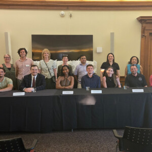 School of Global Business students and alumni standing around a table.