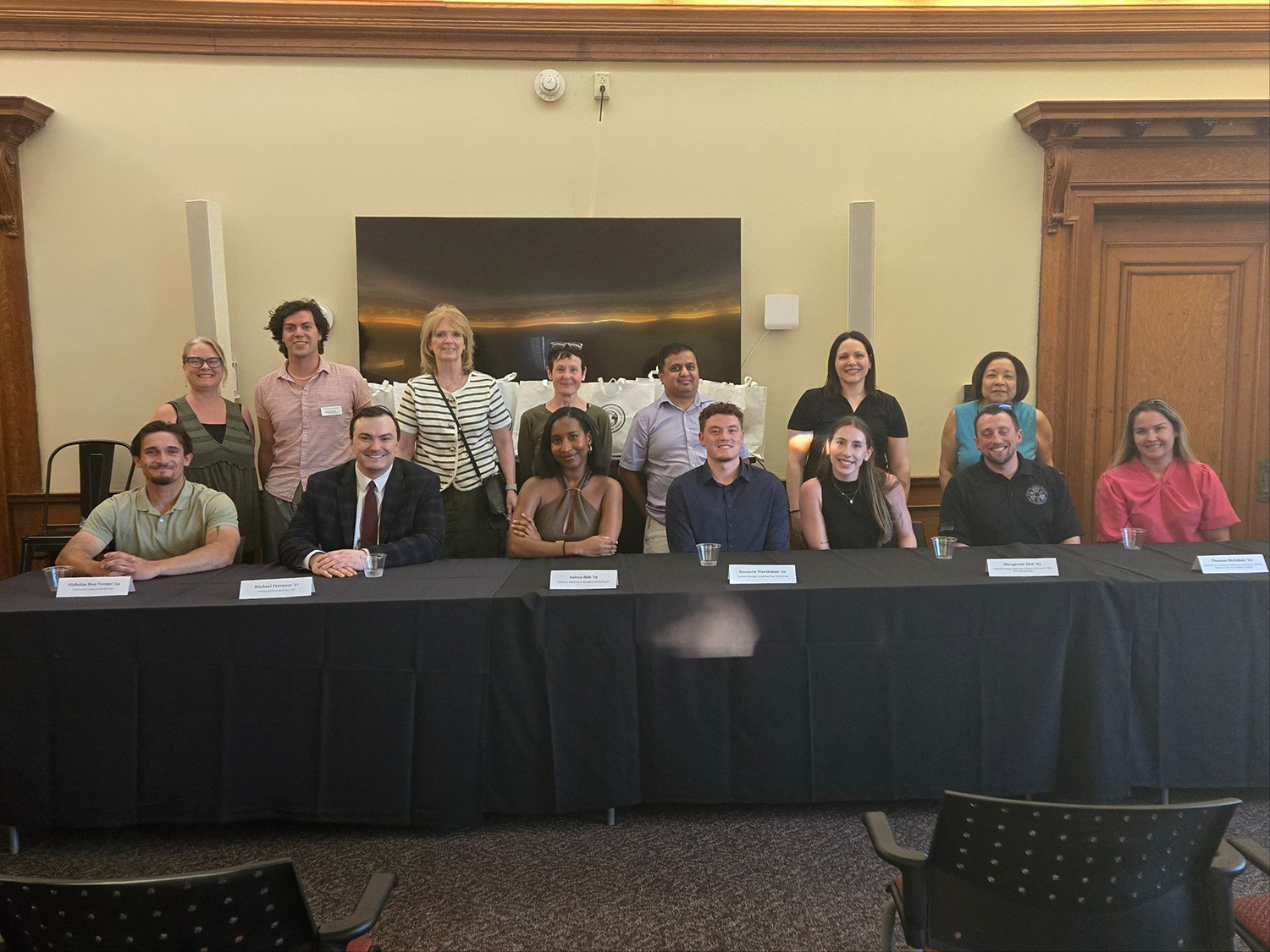 School of Global Business students and alumni standing around a table.