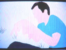 Photo of a tv displaying a man in a blue shirt.