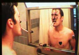Photo of a man looking in the mirror.
