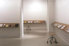 Photo of two empty seats surrounded by books.
