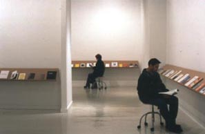 Photo of two people sitting in chairs reading books