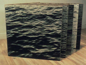 Photo of an ocean with layers behind it.