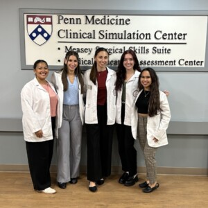 Five Arcadia Physician Assistant students pose for a photo in the Penn Medicine Clinical Simulation Center