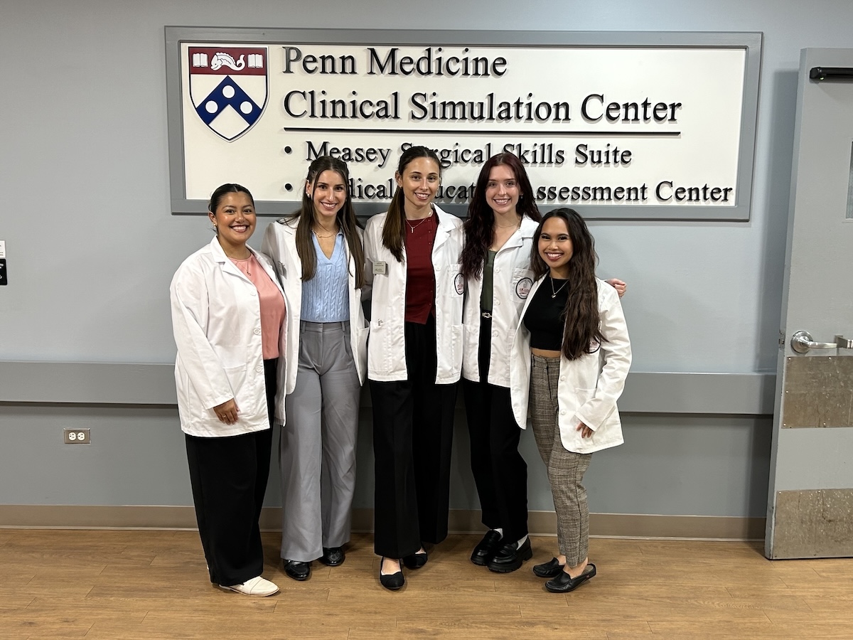 Five Arcadia Physician Assistant students pose for a photo in the Penn Medicine Clinical Simulation Center