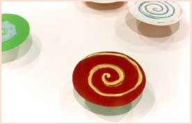 Photo of a painting with candies that have swirly designs.