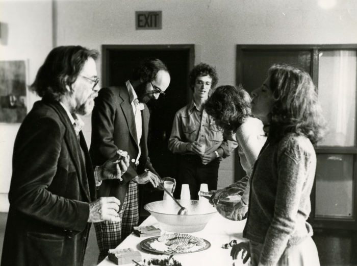 Black and white photo of people around a table.