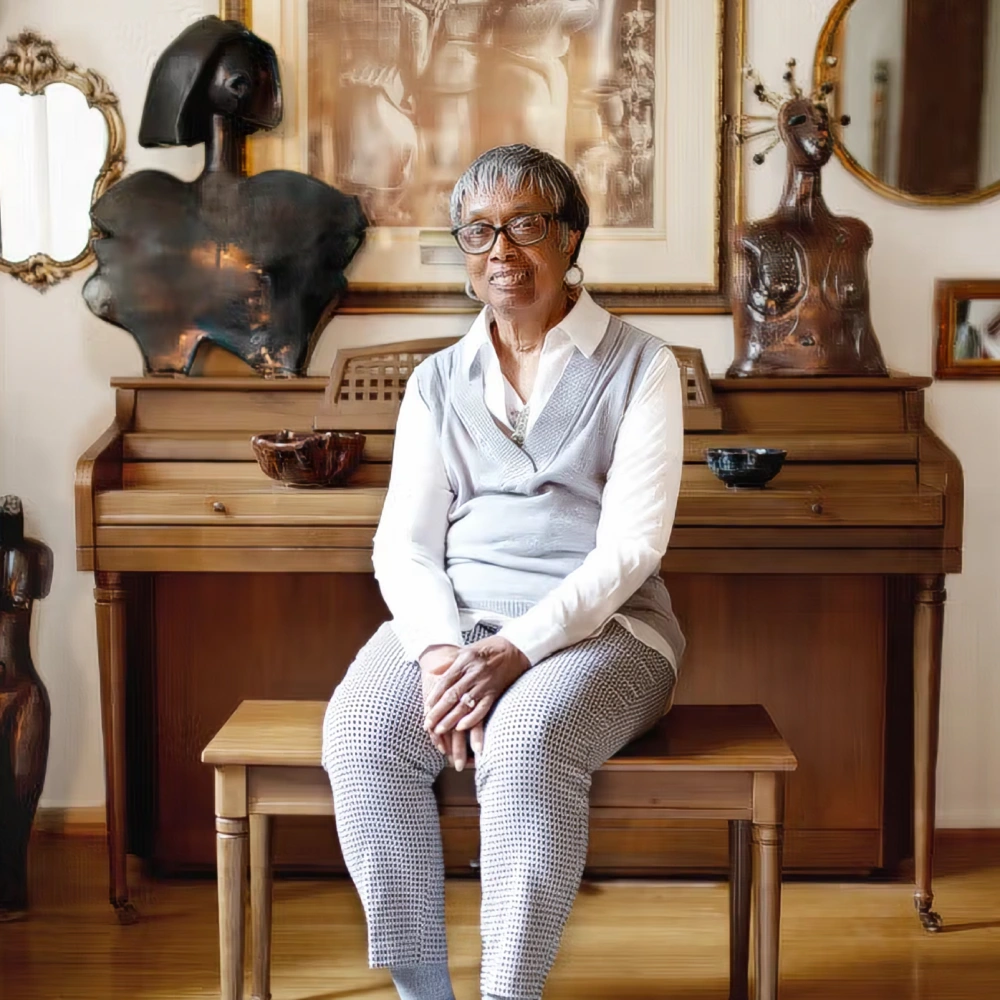Myrtle J. Williams ‘80 sits at a piano.