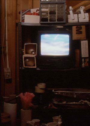 Photo of a tv on a shelving unit.