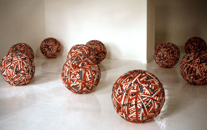 Colored photo of American flags rolled into balls.