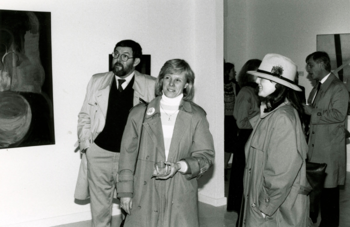 Black and white photo of faculty viewing an exhibit