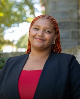Honors Convocation 2026 award recipient Jamerika Grandberry stands outside the Grey Towers Castle and smiles.