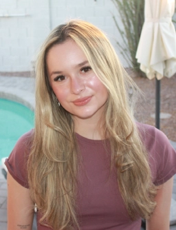 Honors Convocation 2026 award recipient Payton Goltz smiles in her headshot with a pool and white umbrella visible behind her.