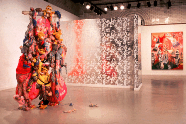 Colorful photo of an exhibit of stuffed animals built high
