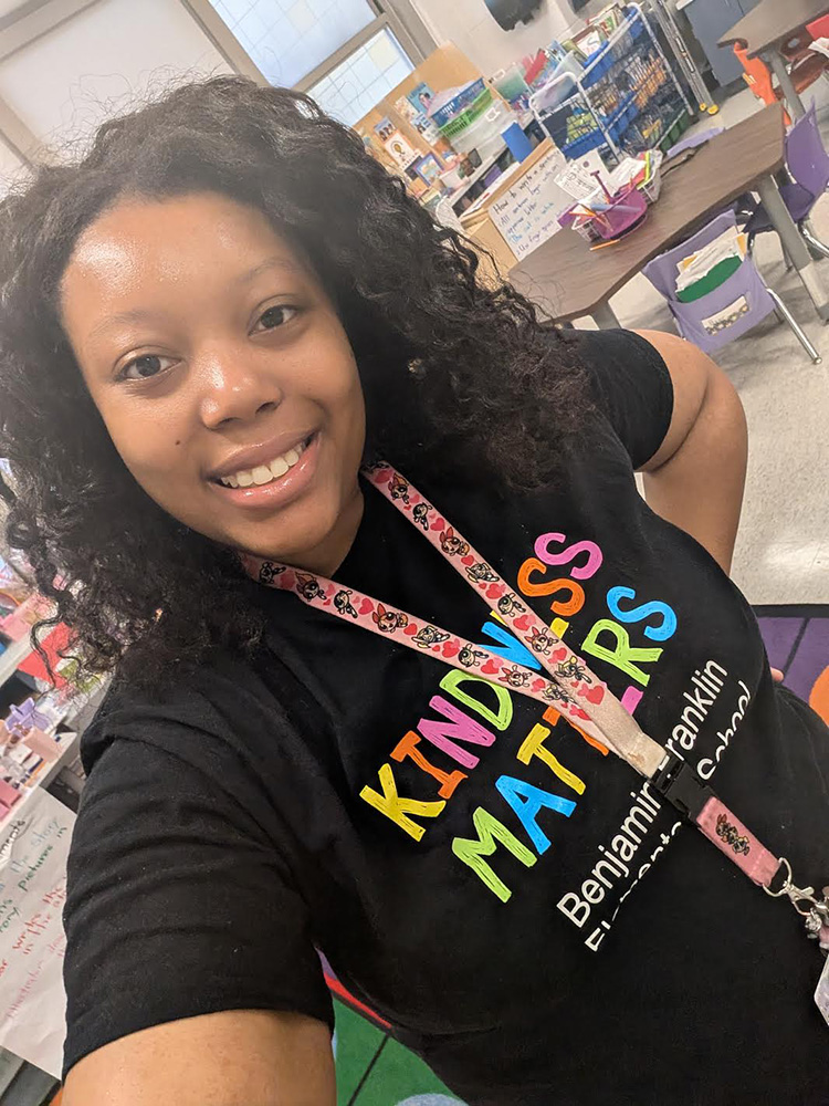 Raine Robinson ’24, ’26MPH poses in her classroom at Benjamin Franklin Elementary School.