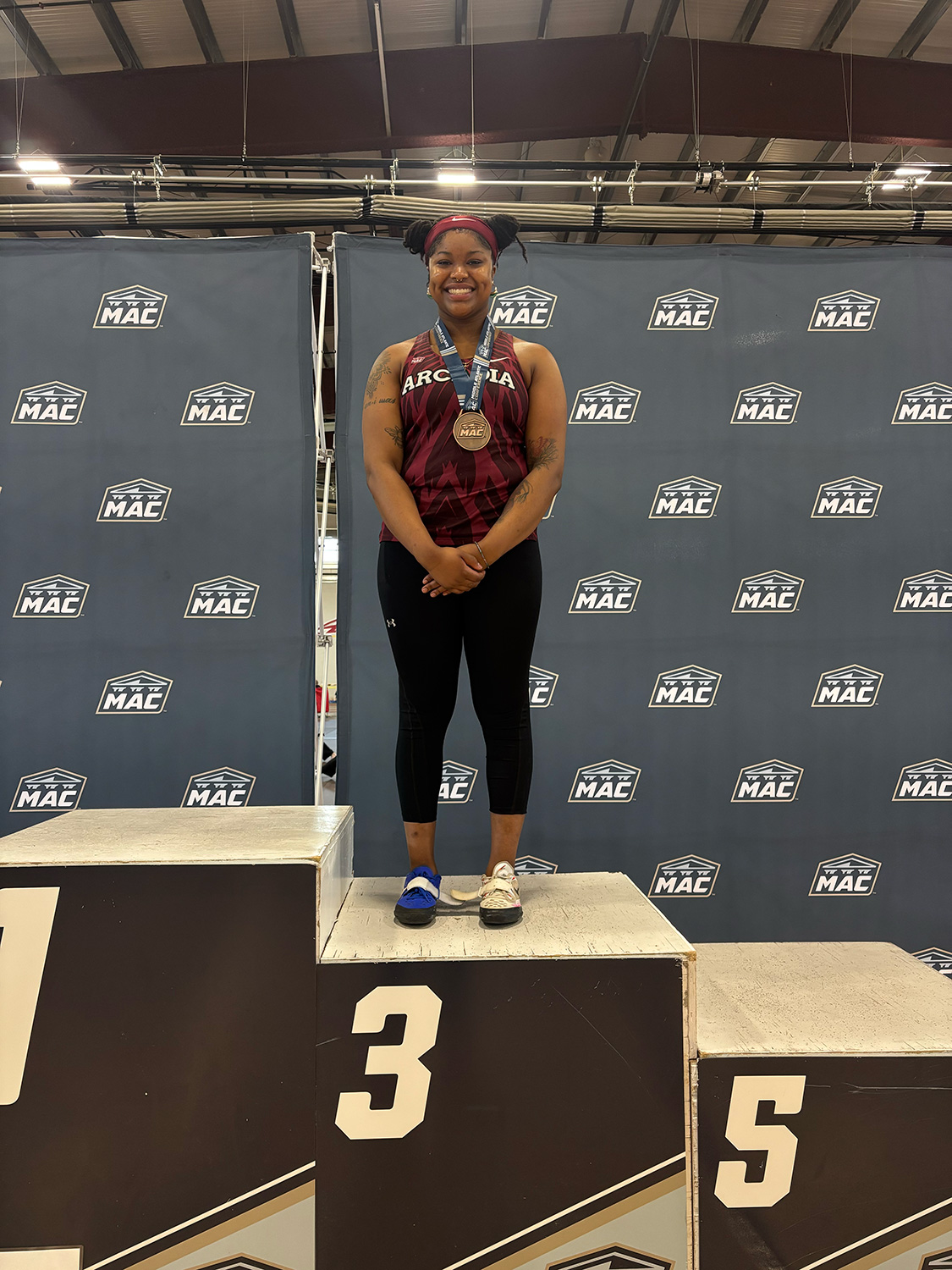 Donya Baxter ’26 wearing a bronze medal.