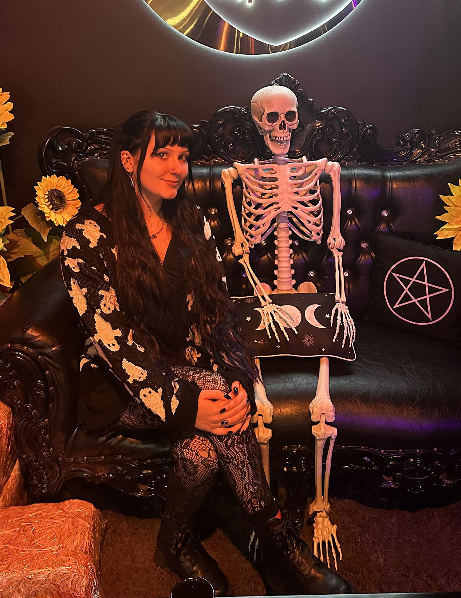 Emily Mayerberg ’26 sitting next to a skeleton.