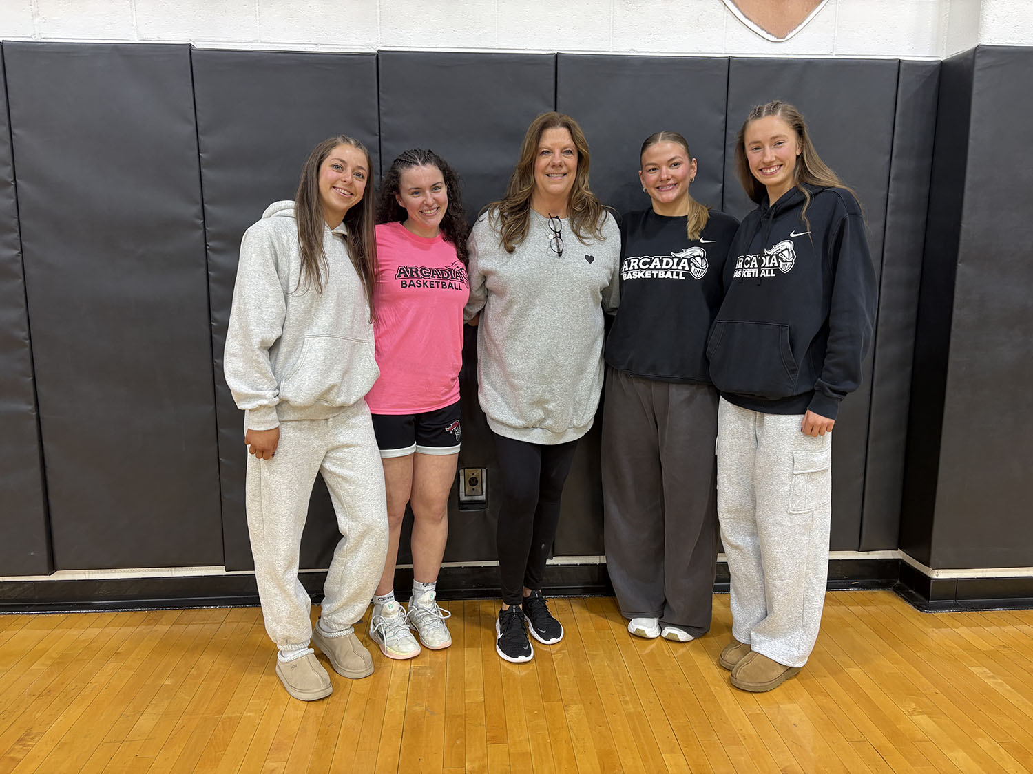 Delaney Bell ’26, a few teammates, and her coach.