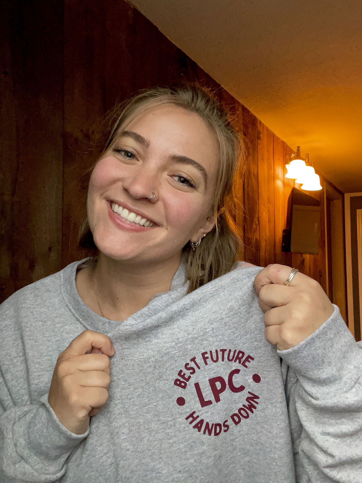 Emma Woehr ’26M wearing a sweatshirt that says "Best Future LPC Hands Down"