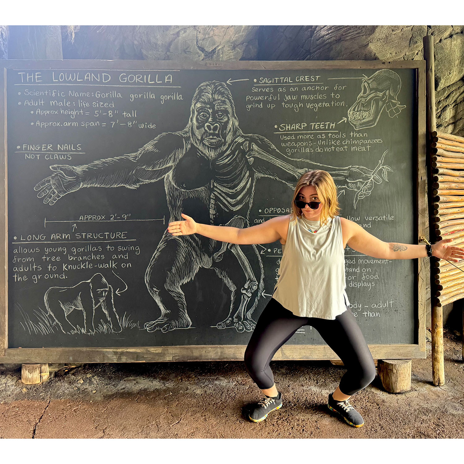 Emma Woehr ’26M in front of a chalkboard with a gorilla on it.