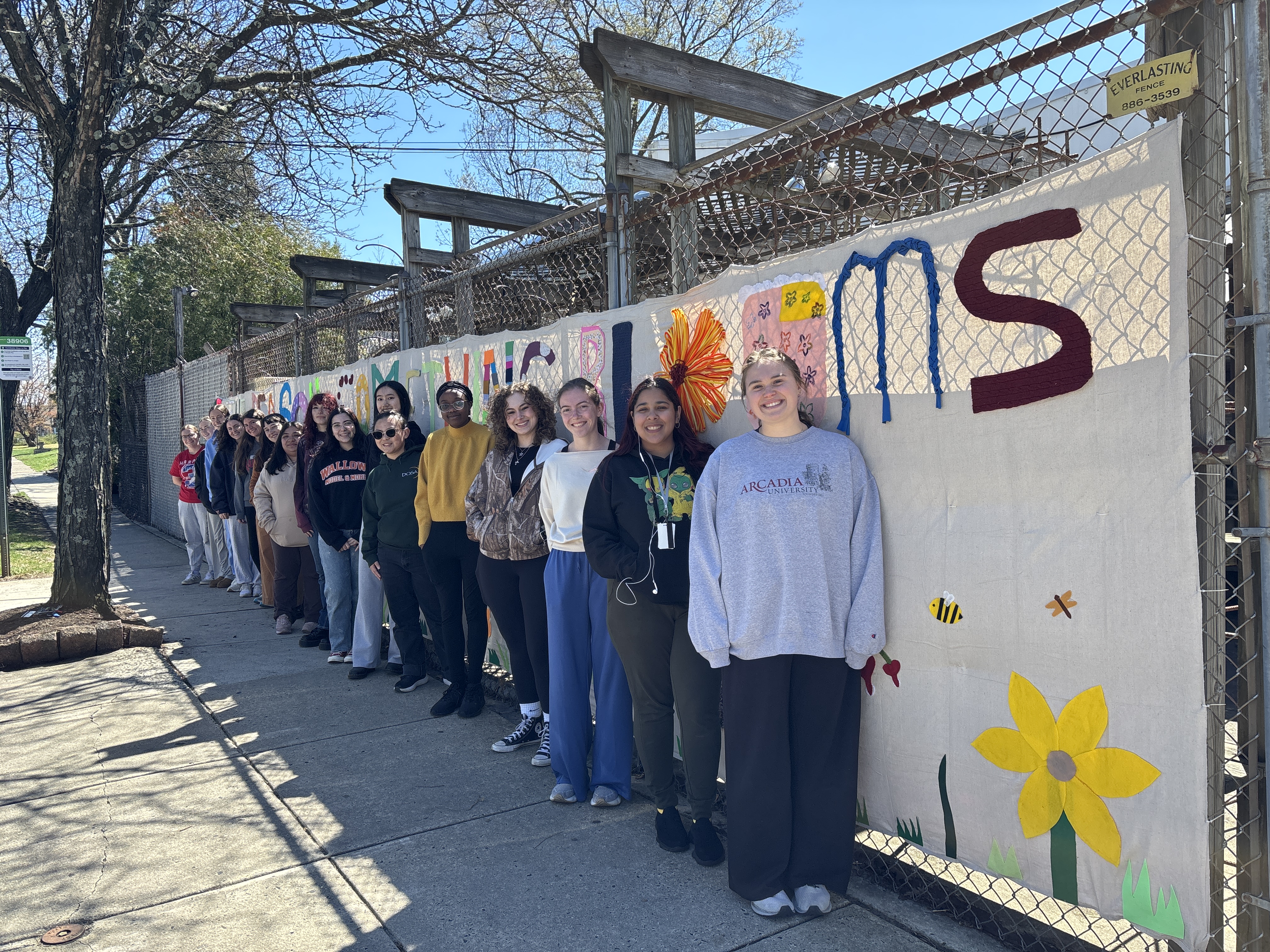 Students lineup in front of their 2026 Craftivism project with the Arcadia Honors program.