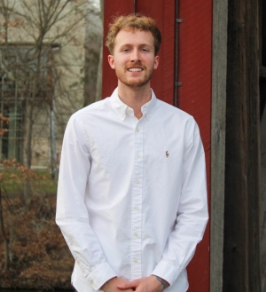 Honors Convocation 2025 award recipient Daniel Bridal Leitholf folds his hands in front of him and smiles outside.