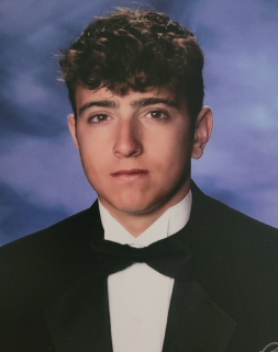 Honors Convocation 2026 award recipient Giacomo Vacchio stands in front of a blue background in his headshot.