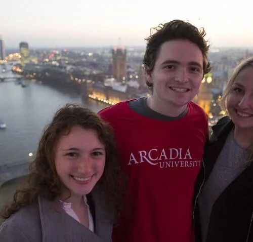 Three Arcadia students standing above the River Thames