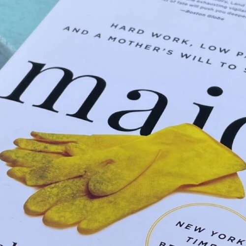 A pamphlet that reads "maid" with yellow gloves