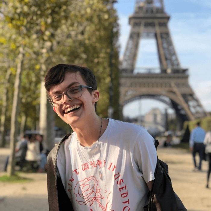 Jacob McCrea smiles at the camera in Paris