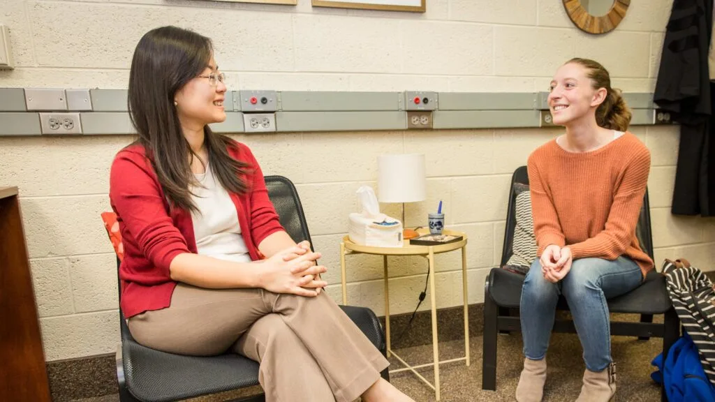 Dr. Cathy Lee talks with a counseling student.