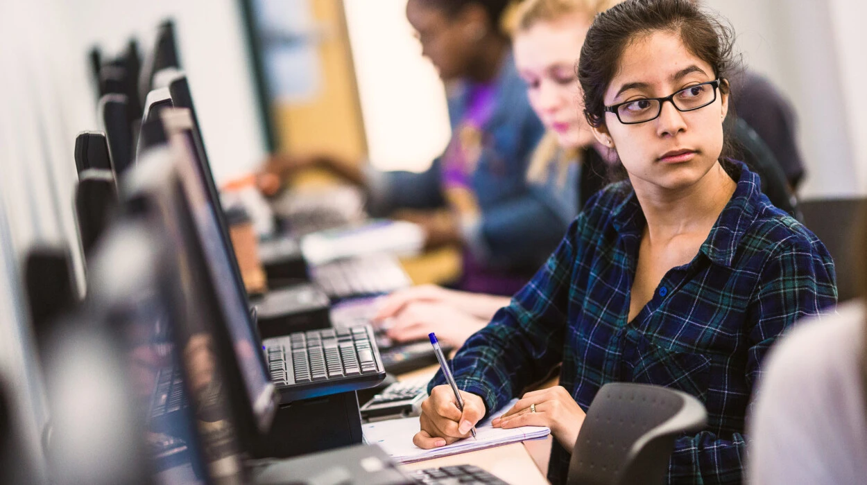 Student listens in a computer lab.
