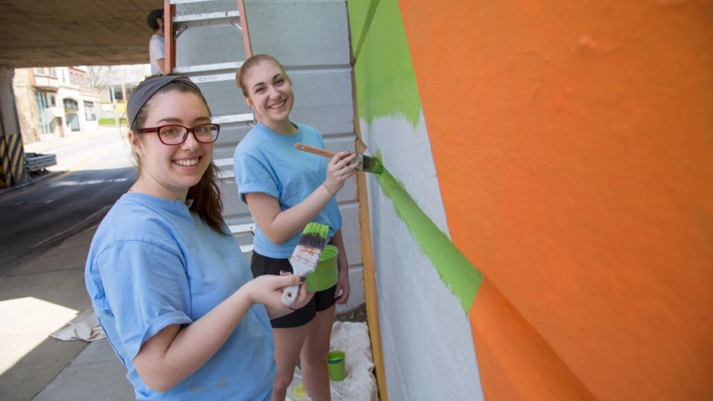 Students paint a mural.