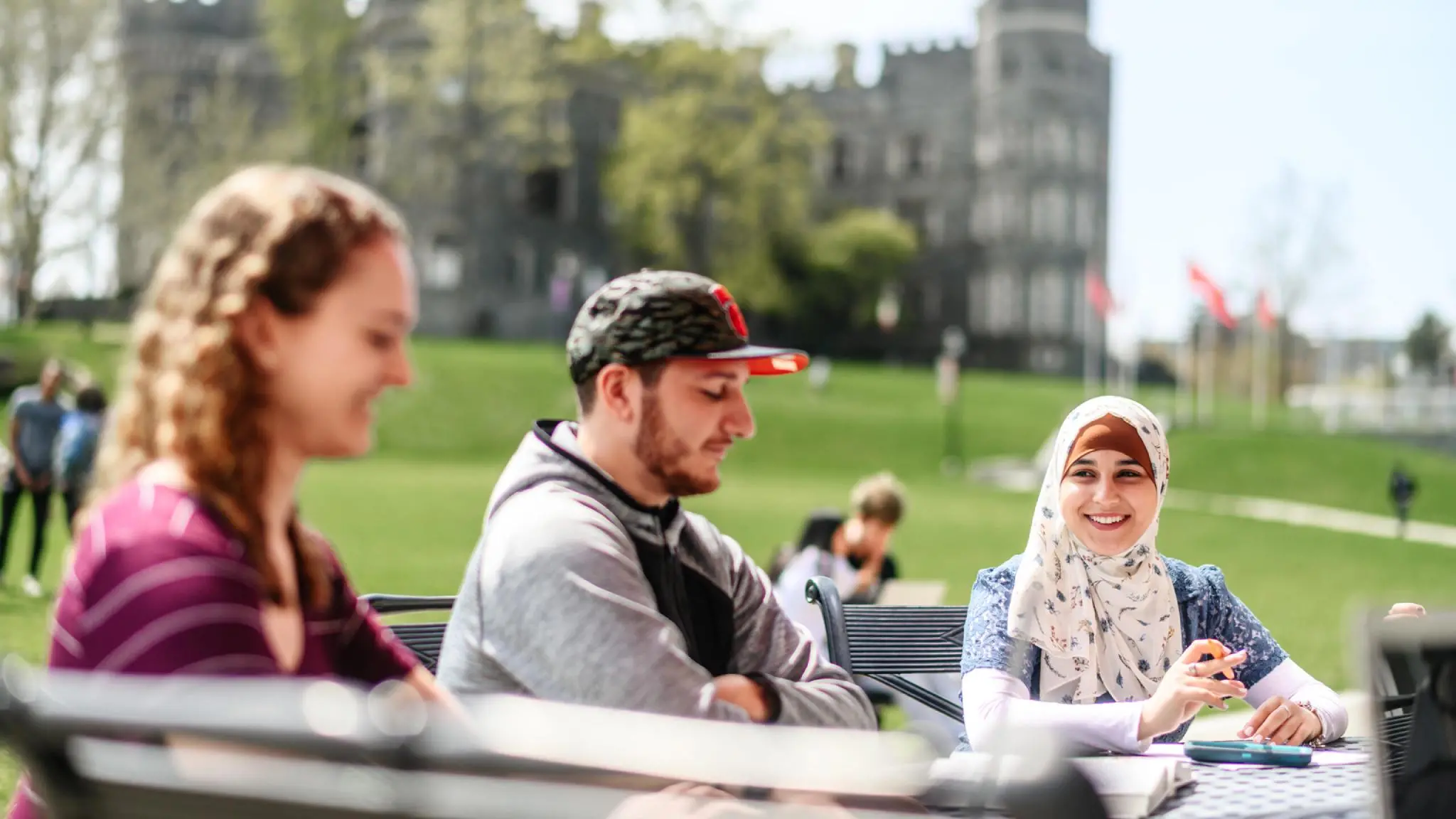 Transfer students study together outside by Grey Towers.