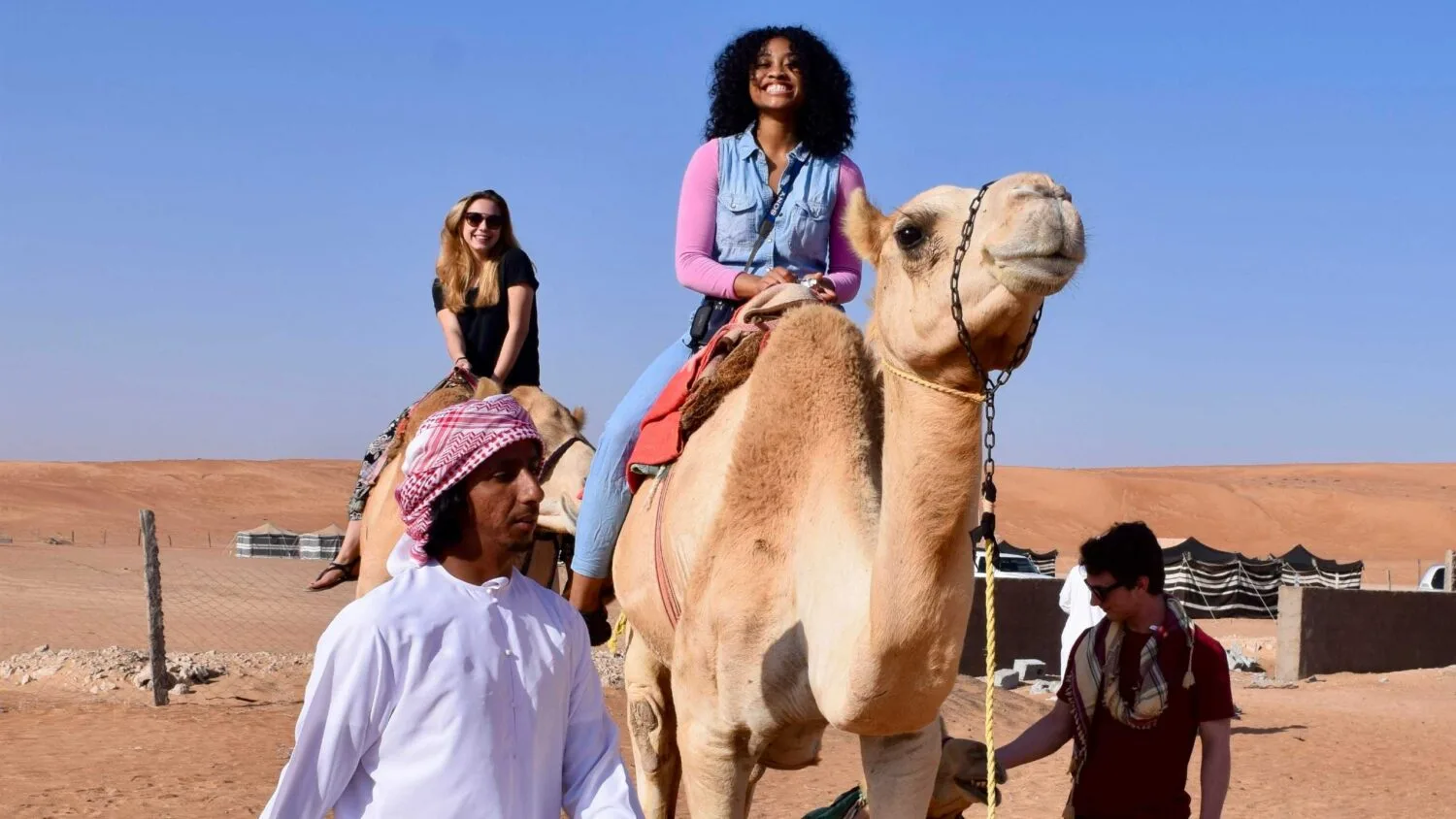 Arcadia students ride camels overseas.