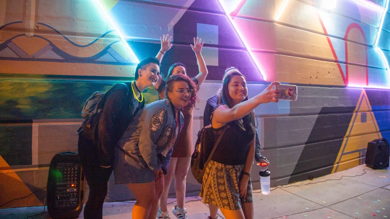 Students take a selfie during a visit to a food truck event.
