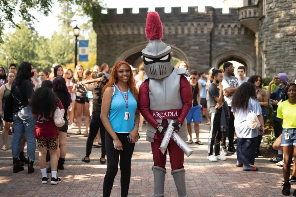 Student and Arcadia Knight mascot at parade.