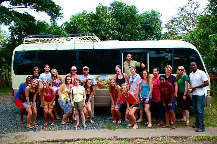 IPCR students by a bus overseas in the tropics.