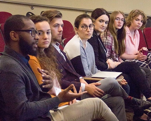 IPCR students attend a lecture in a theater room.