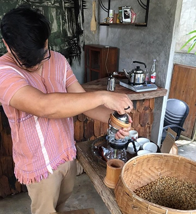 A man prepares a meal in the tropics.