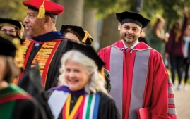 President Ajay Nair, Ph.D. walking at graduation.