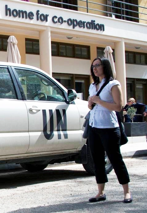 An IPCR student stands by the Home for Co-operation building entrance.