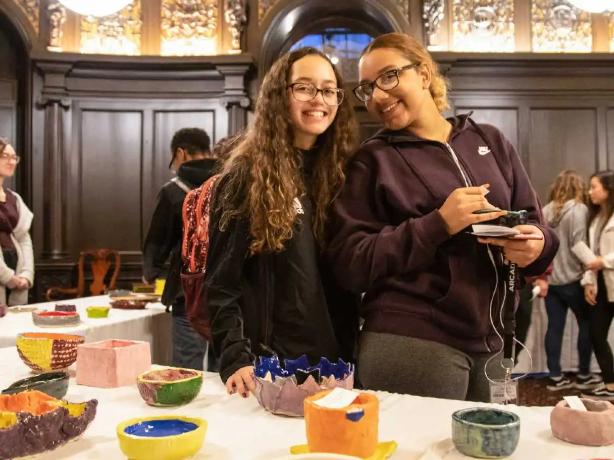 Two students smiling at camera during Empty Bowl