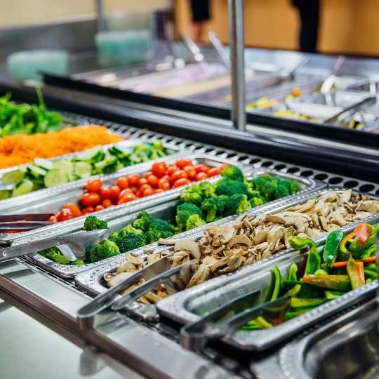 A brightly colored selection of food at a self-serve bar at dining services.