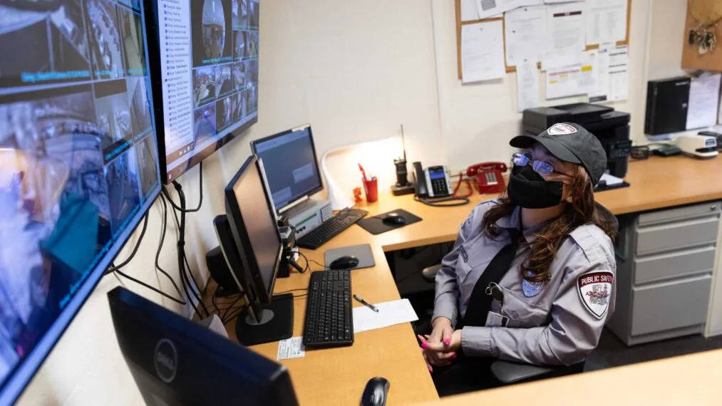 Security officer observes surveillance screens