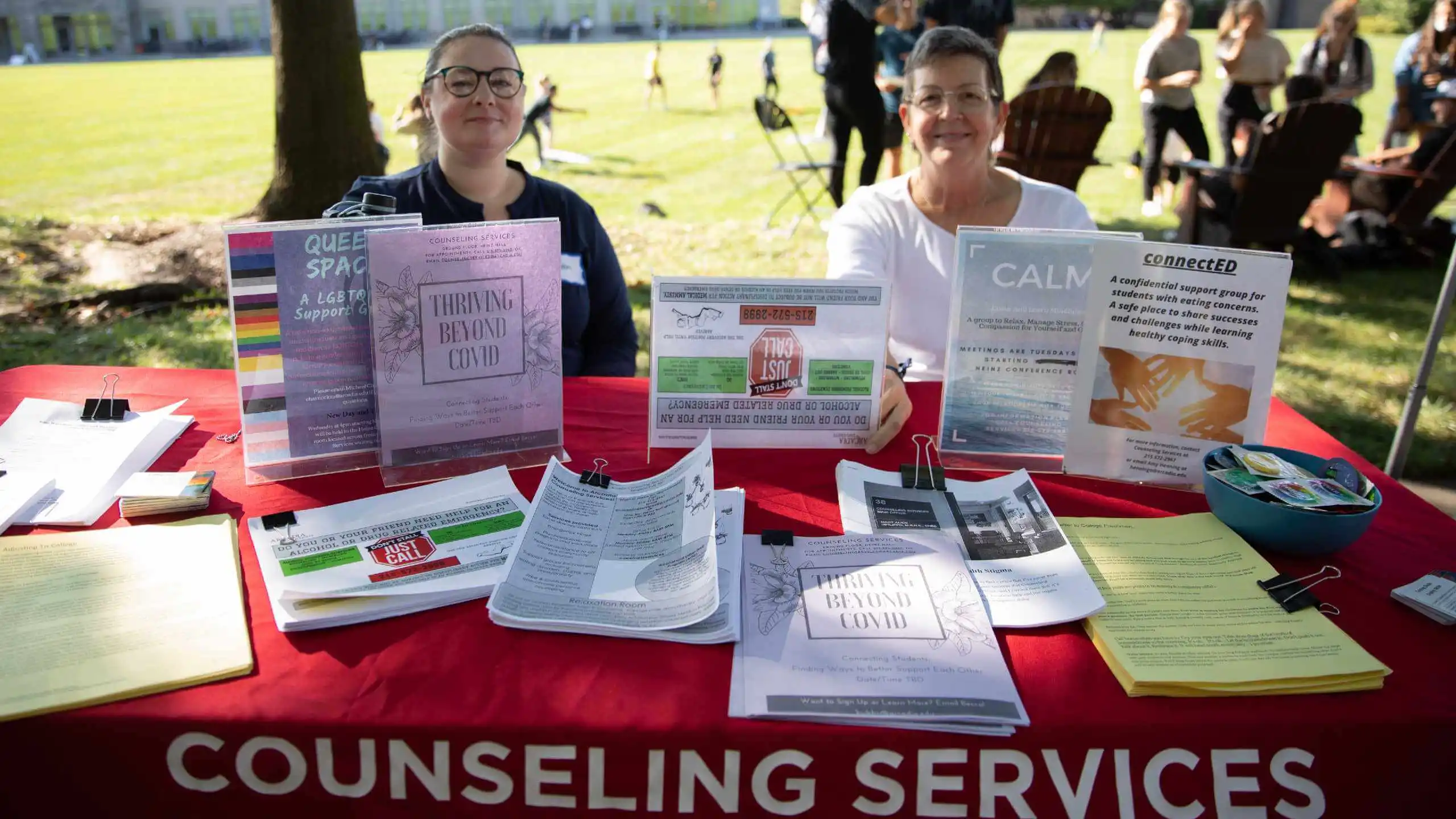 Counseling Services display and staff at an outdoor Activities Fair